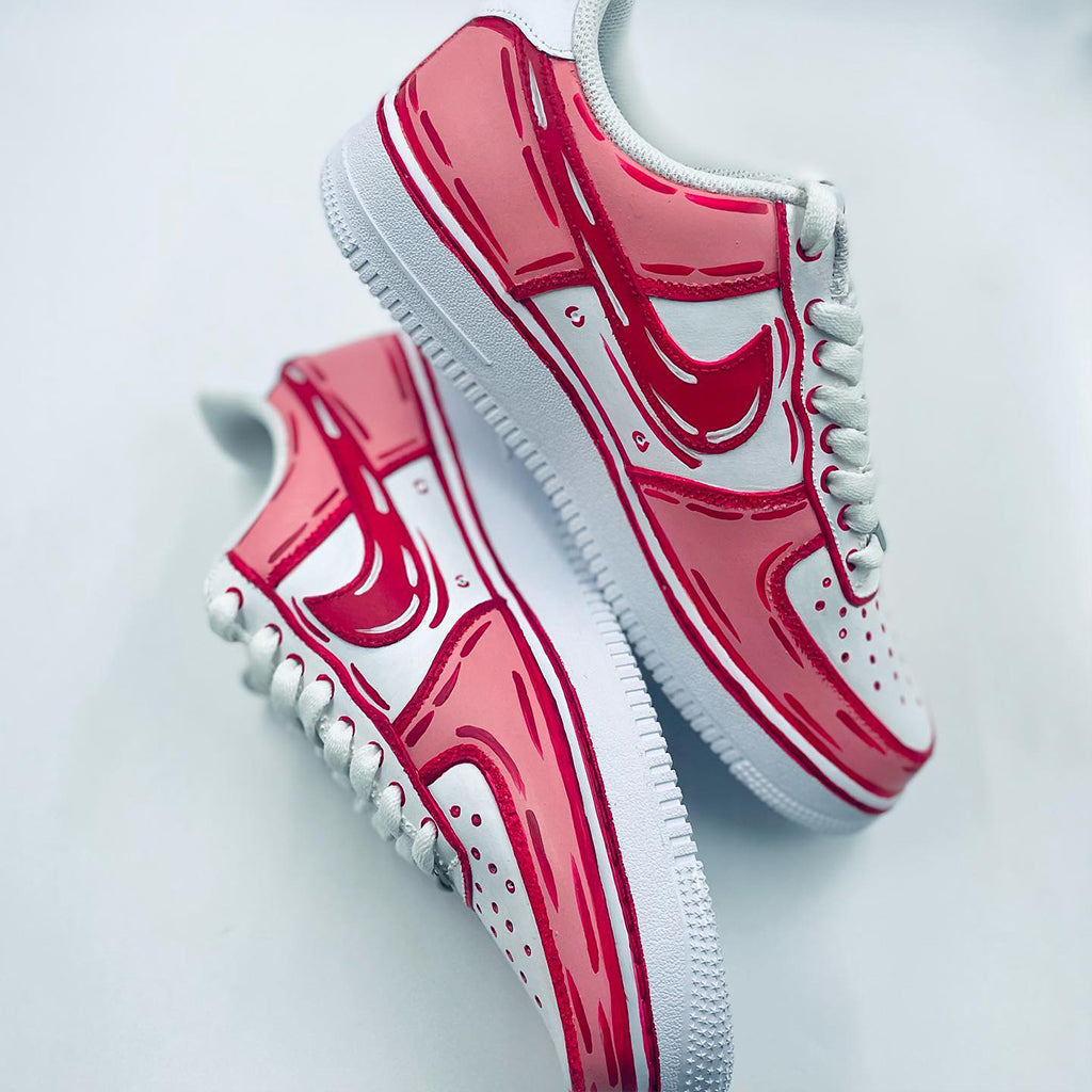 Customized Nike Air Force 1 sneakers with a cartoon style design in pink and white.